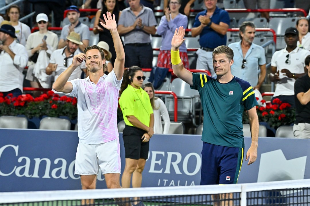 Two male players lifting their hands