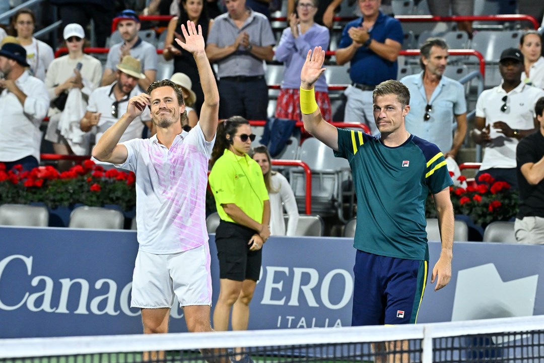 Two male players lifting their hands