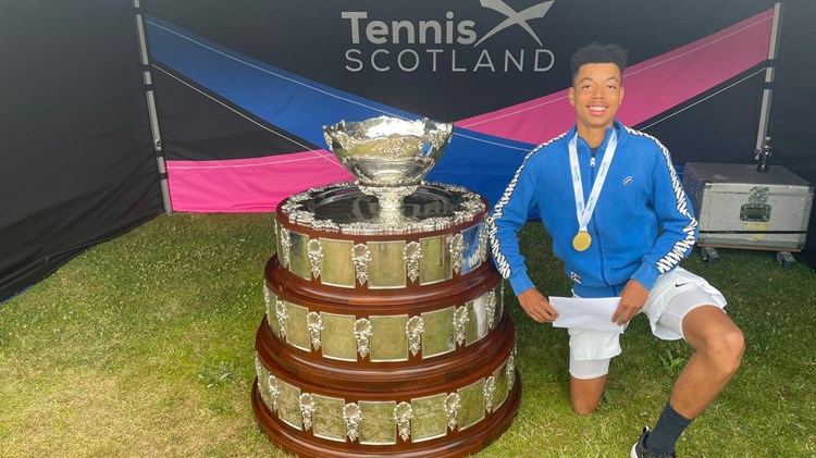 Conor Flynn posing next to US16 championship trophy