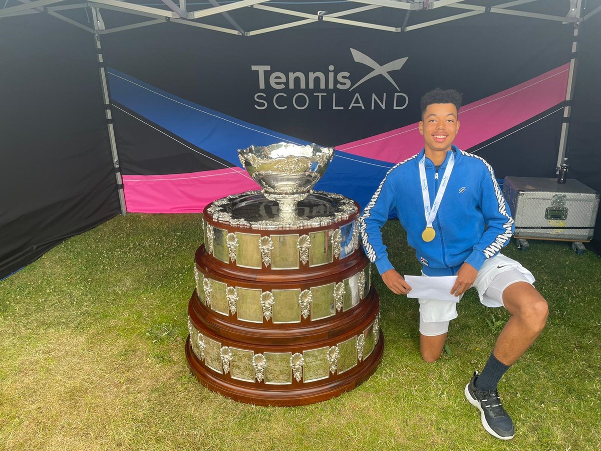 Conor Flynn posing next to US16 championship trophy