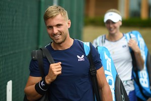 Male tennis player with a racket bag over his shoulder