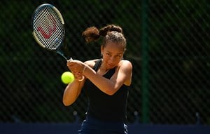 Female tennis player returning a serve
