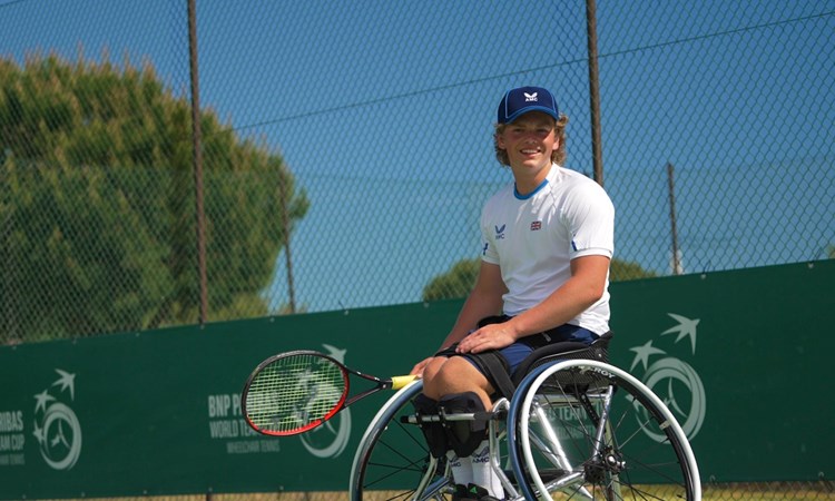 Wheelchair tennis star Ben Bartram sat in his wheelchair on court at the World Team Cup while holding his tennis racket