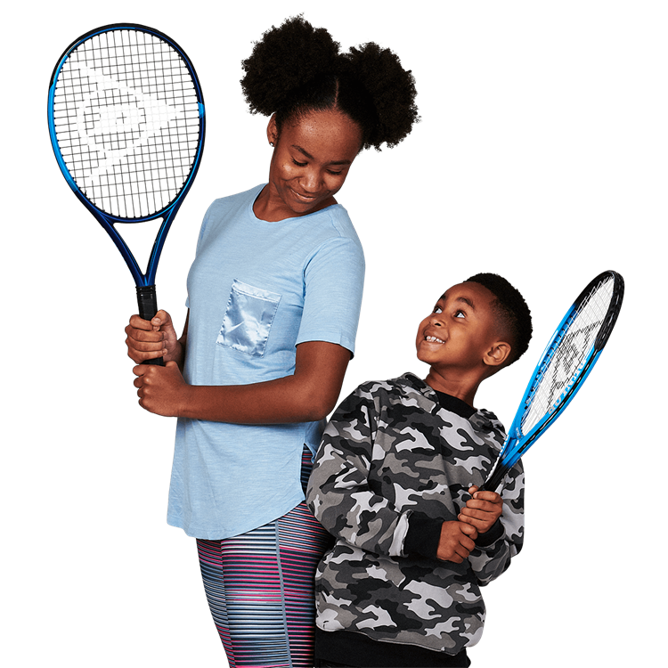 Boy looking up at a girl holding a tennis racket