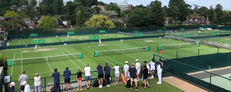 A group of people watching tennis matches