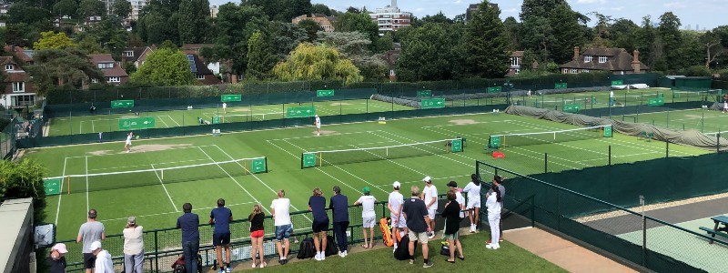 A group of people watching tennis matches