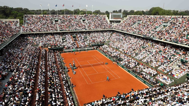Clay court match with a stadium full of audience