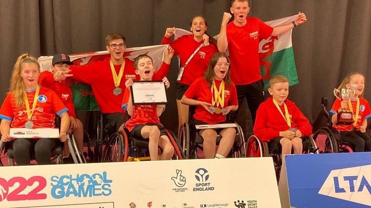 Disability tennis players cheering for a picture