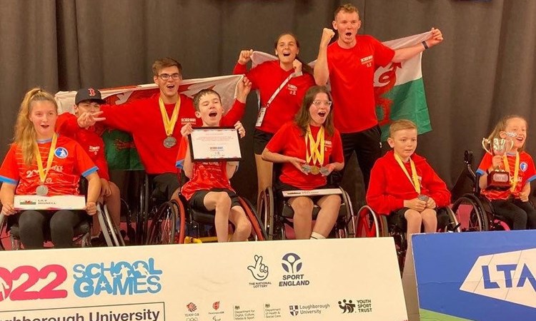 Disability tennis players cheering for a picture