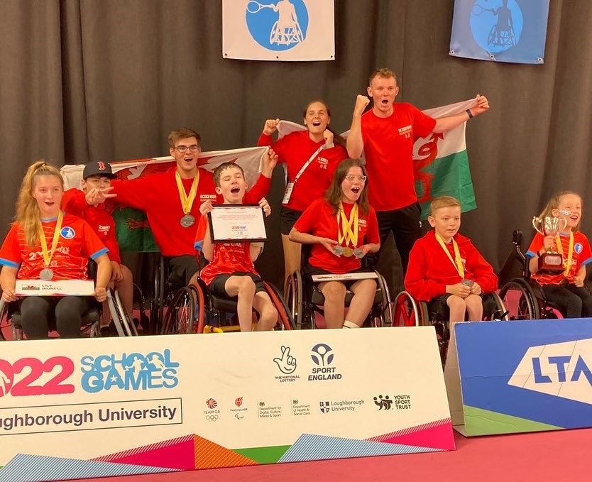 Disability tennis players cheering for a picture