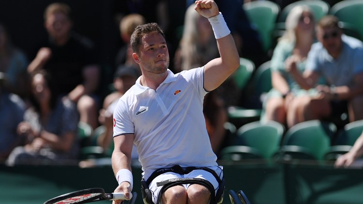 Wheelchair tennis player cheering after a game win