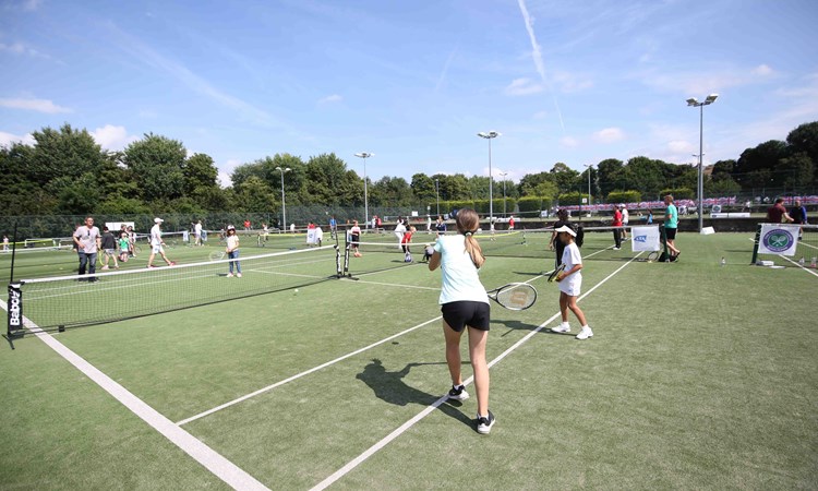 Tennis lessons taking place outside 