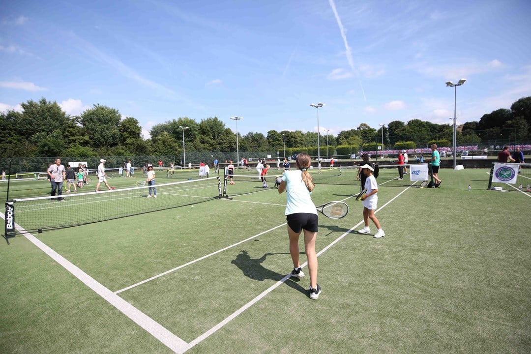 Tennis lessons taking place outside 