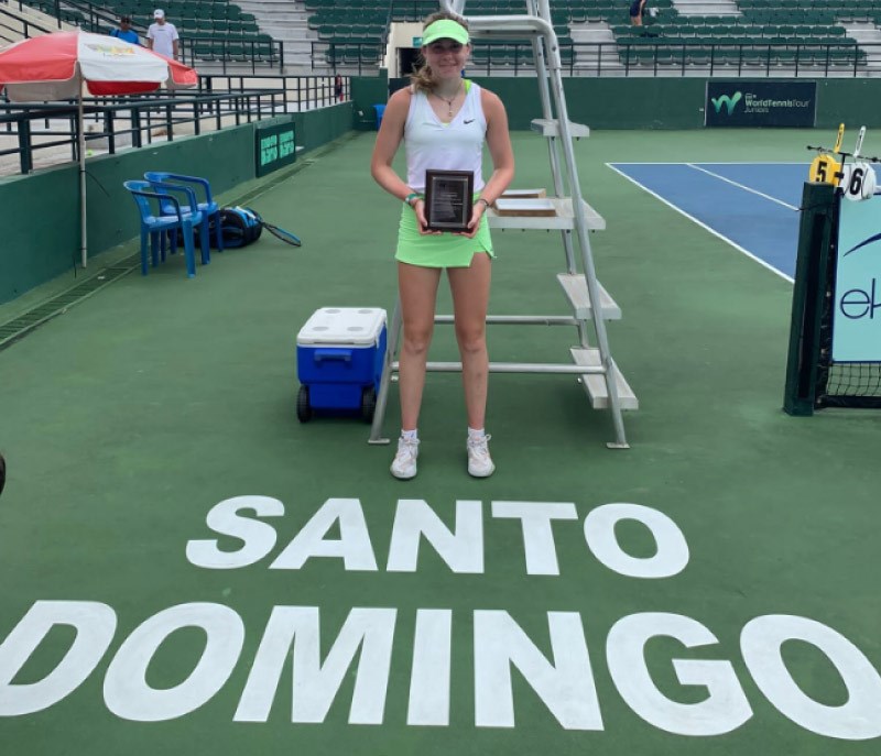 Female tennis player posing with a trophy