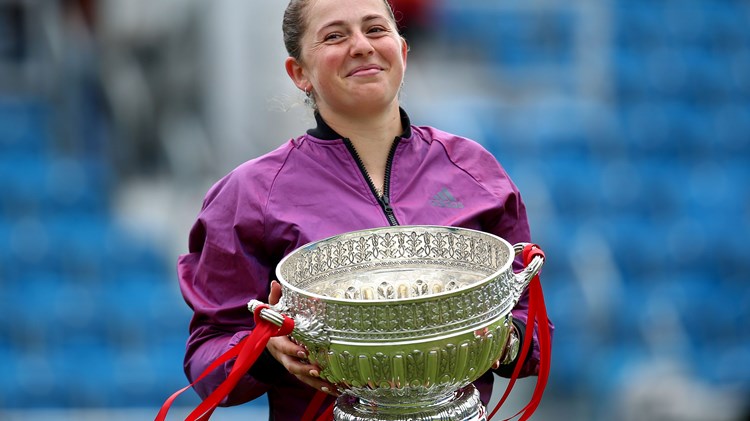 Female tennis player holding a trophy