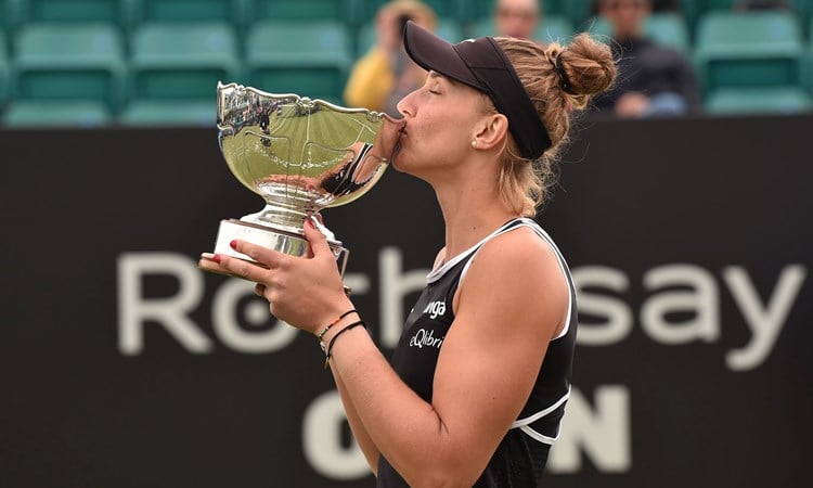 Female tennis player kissing a trophy