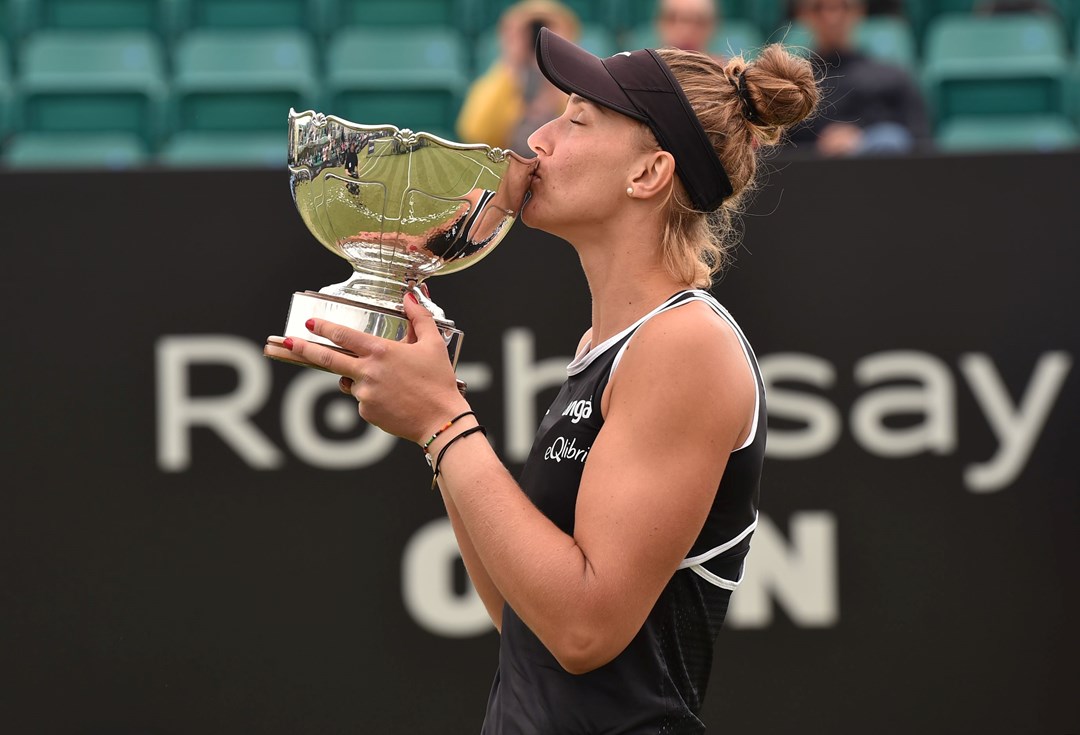 Female tennis player kissing a trophy