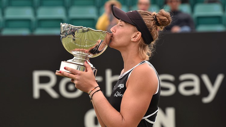 Female tennis player kissing a trophy