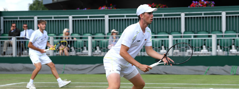 Jonny O'Mara and Aidan McHugh on court playing a doubles match