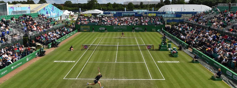 An action shot of two players on court with spectators in the stands