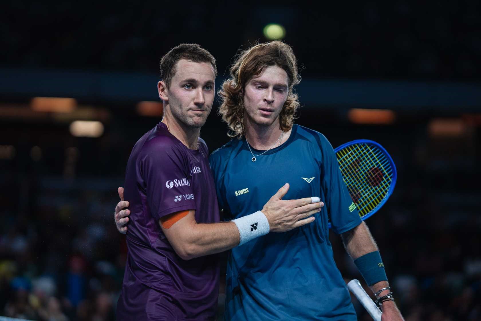Casper Ruud and Andrey Rublev hug at the net after a match at the Ultimate Tennis Showdown