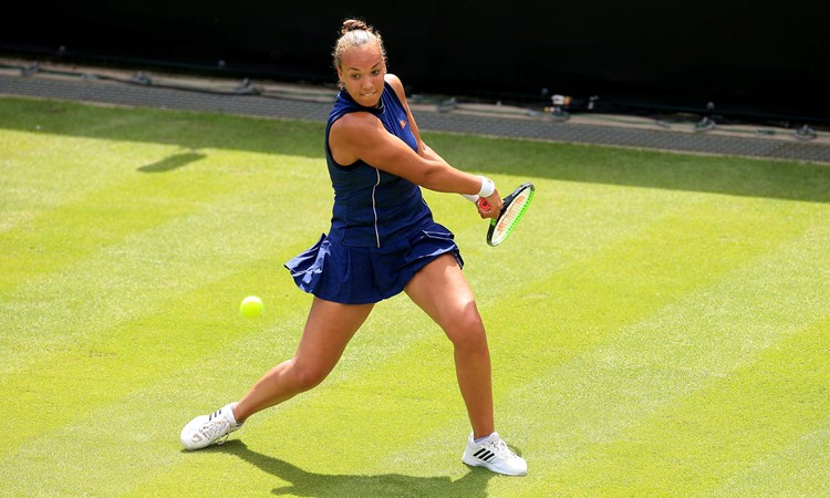 Freya Christie swinging a tennis racket