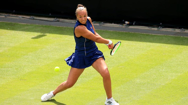 Freya Christie swinging a tennis racket