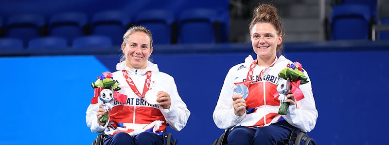 Lucy Shuker and Jordanne Whiley holding medals and smiling