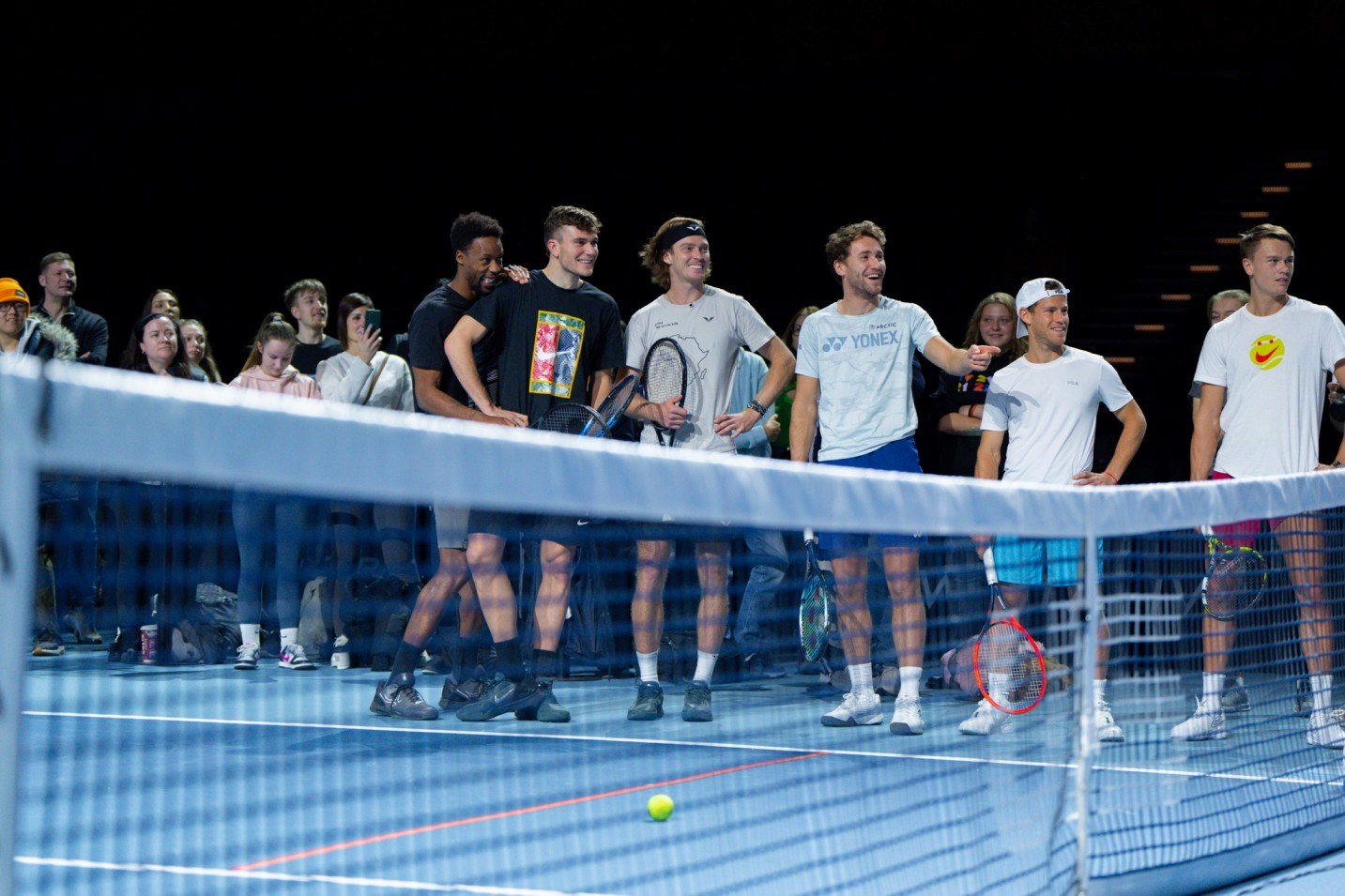 Gael Monfils, Jack Draper, Andrey Rublev, Casper Ruud, Diego Schwartman and Holger Rune stood on court at UTS while spectators take pictures of them 