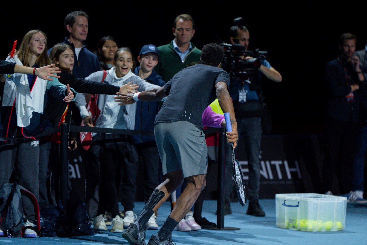 Gael Monfils high fiving  kids who are watching  his practice session at UTS