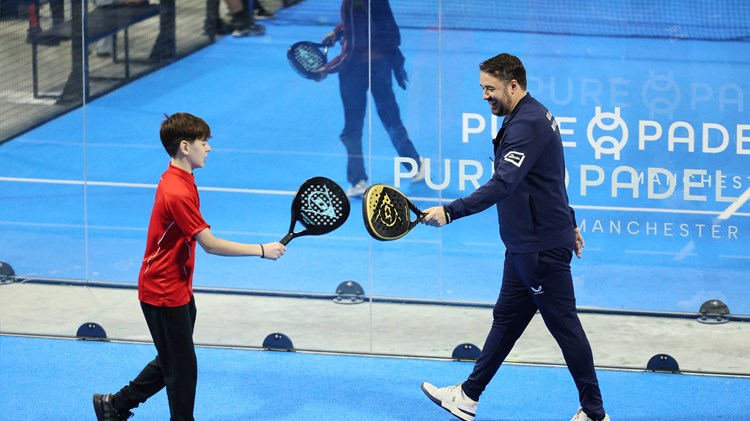 Jason Manford celebrates winning a point at a schools padel event in Manchester