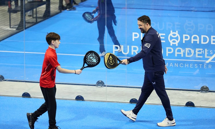 Jason Manford celebrates winning a point at a schools padel event in Manchester
