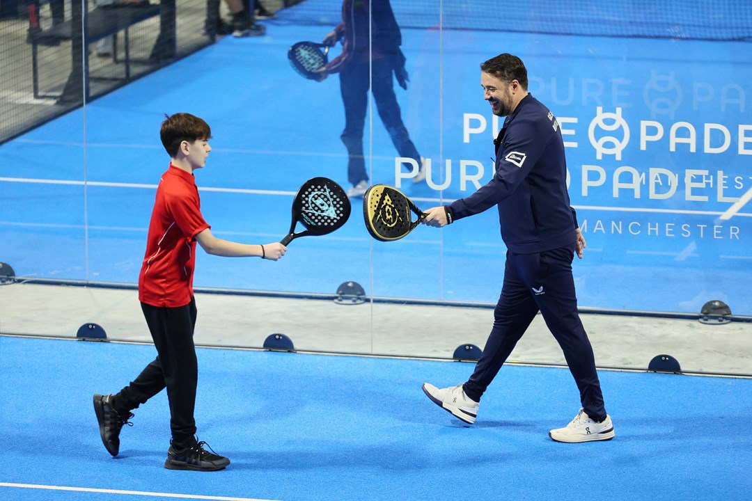 Jason Manford celebrates winning a point at a schools padel event in Manchester