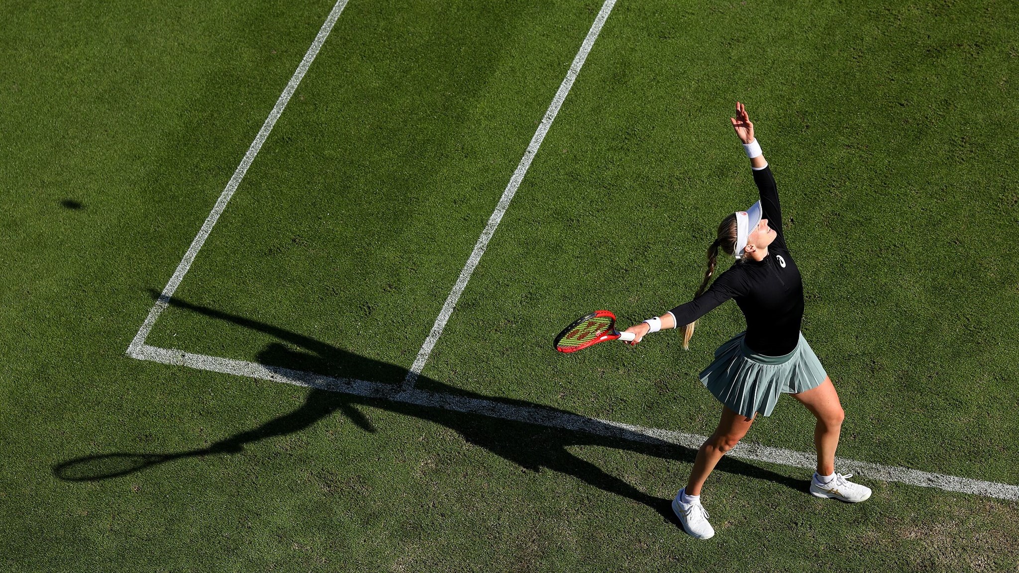 Harriet Dart of Great Britain serves during her first round women's doubles match with fellow Brit Heather Watson against Jelena Ostapenko of Latvia and Cori Gauff of USA 