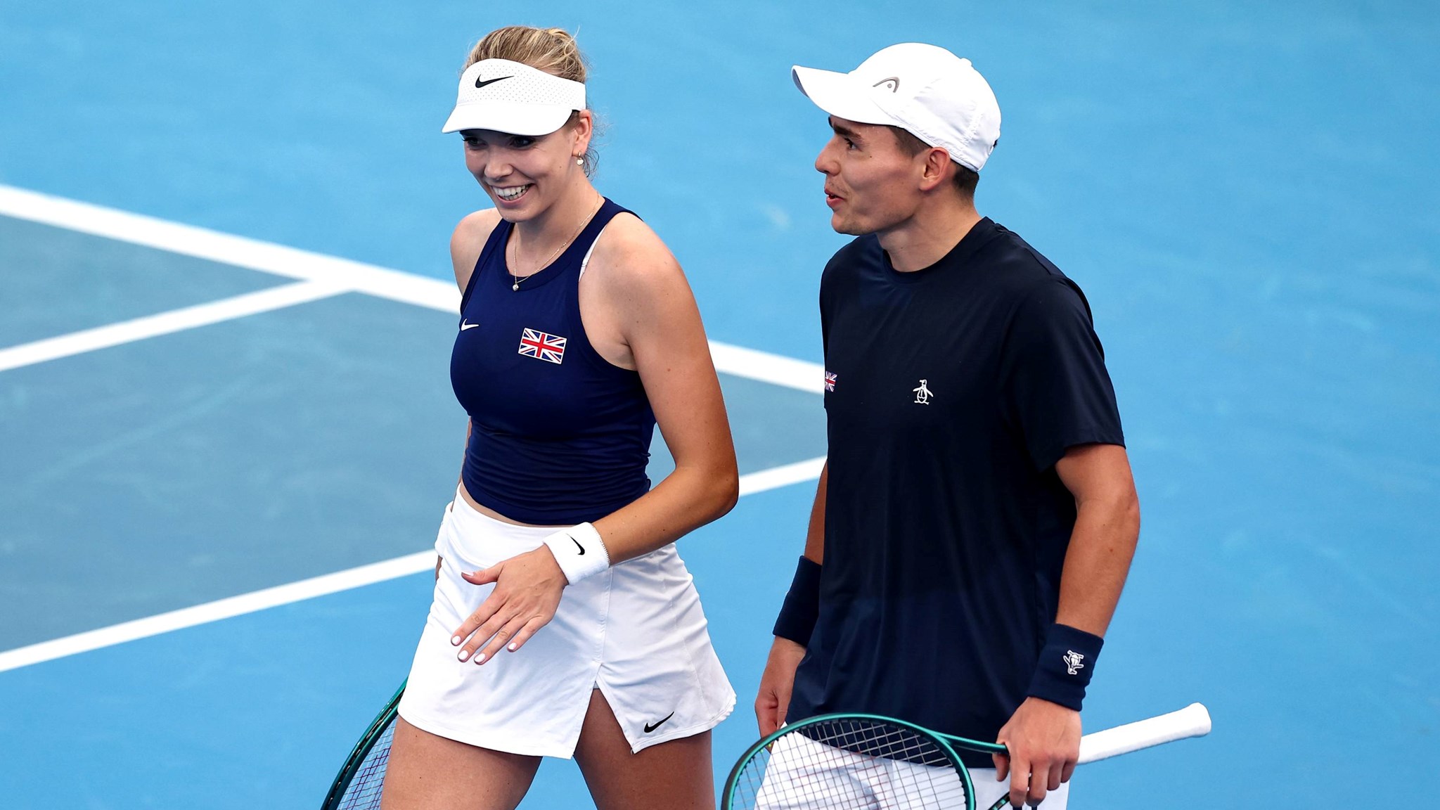Katie Boulter and Charles Broom laughing together on court at the United Cup