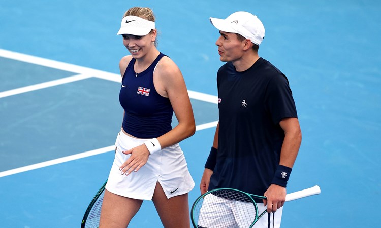 Katie Boulter and Charles Broom laughing together on court at the United Cup