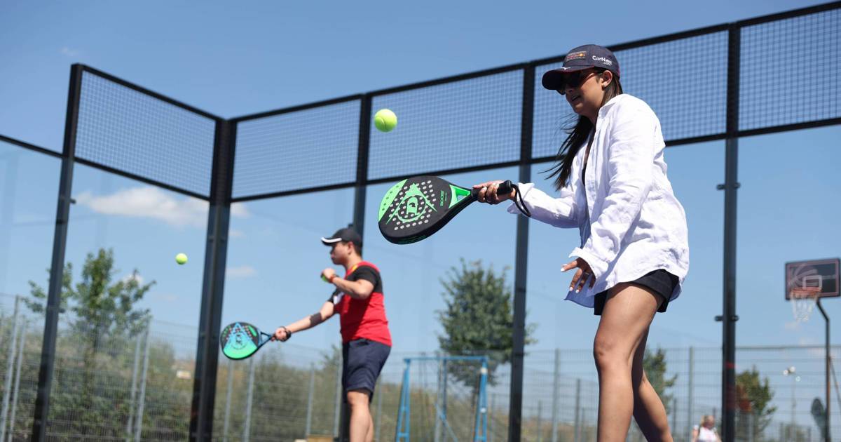 Two padel players practising on an outdoor court