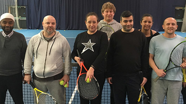 Players pose for a group picture at the net at a Lee valley coaching session