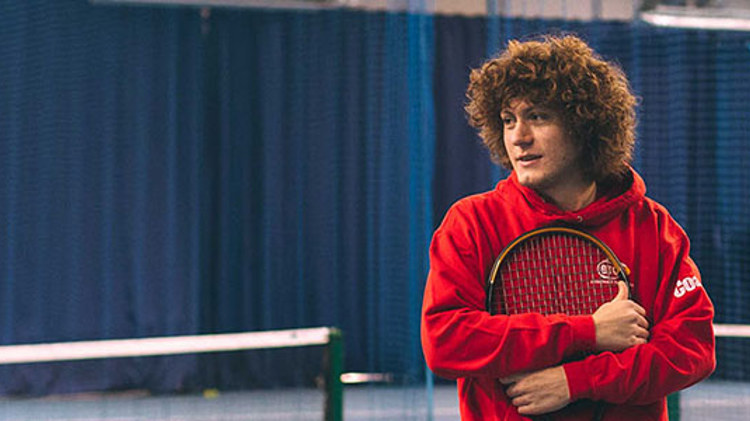 Assistant Manager Rob Start on a tennis court