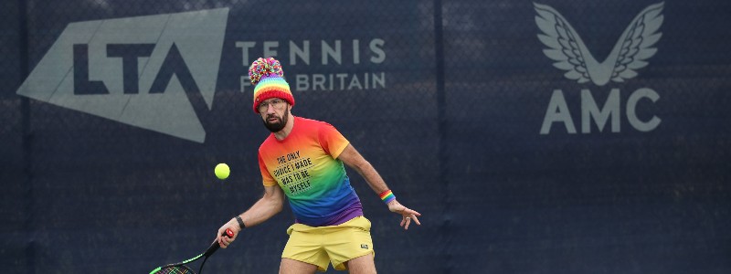 A male tennis player on court at the Pride in Tennis event at the National Tennis Centre