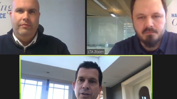 Zoom call between three men with national officiating conference in the background