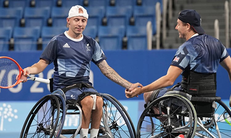 Two paralympic players shaking hands 