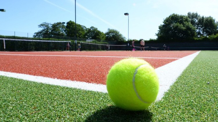 Tennis ball on a clay court