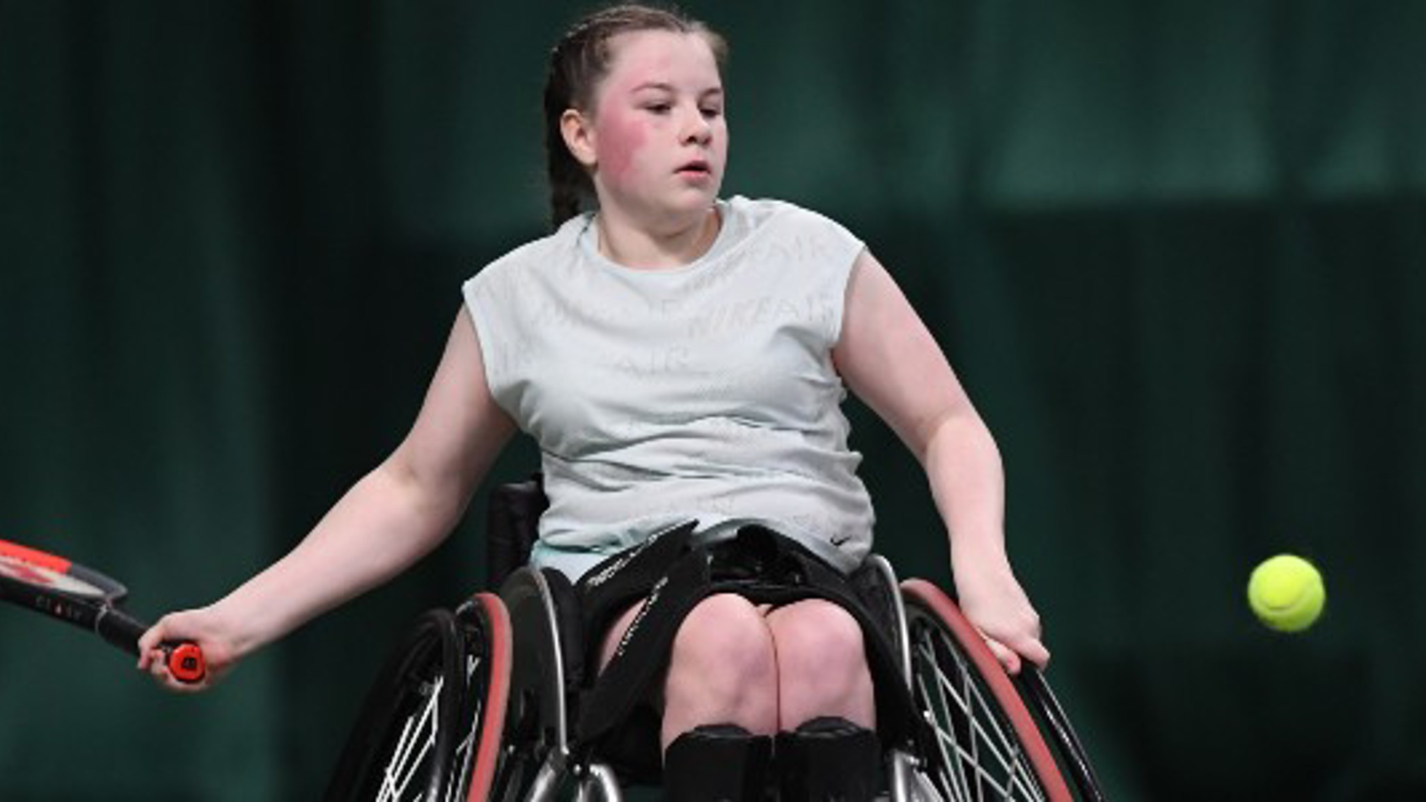 Girl playing tennis in wheelchair
