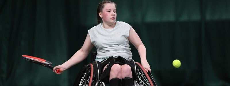 Girl playing tennis in wheelchair