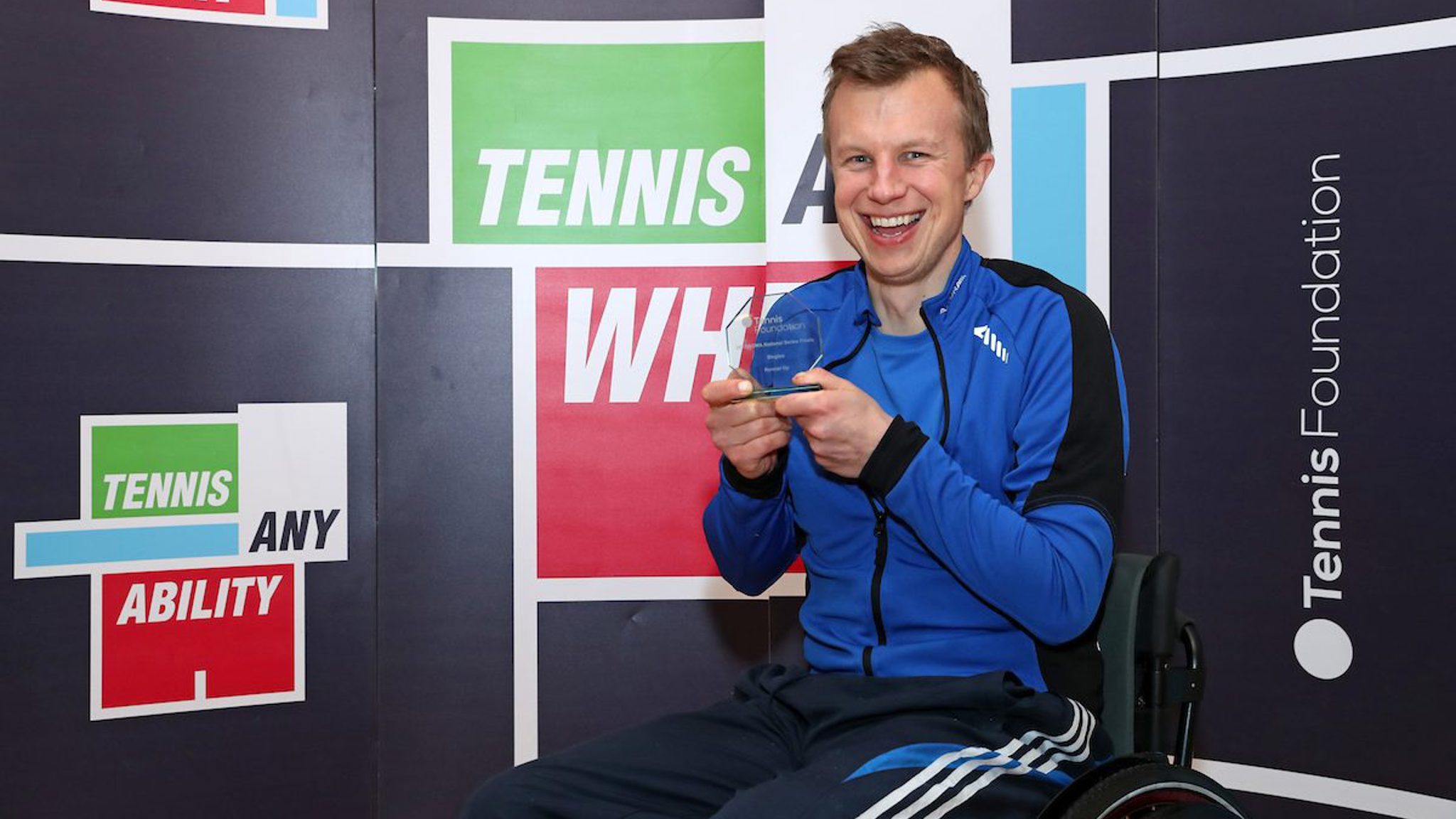 Philip holding his award