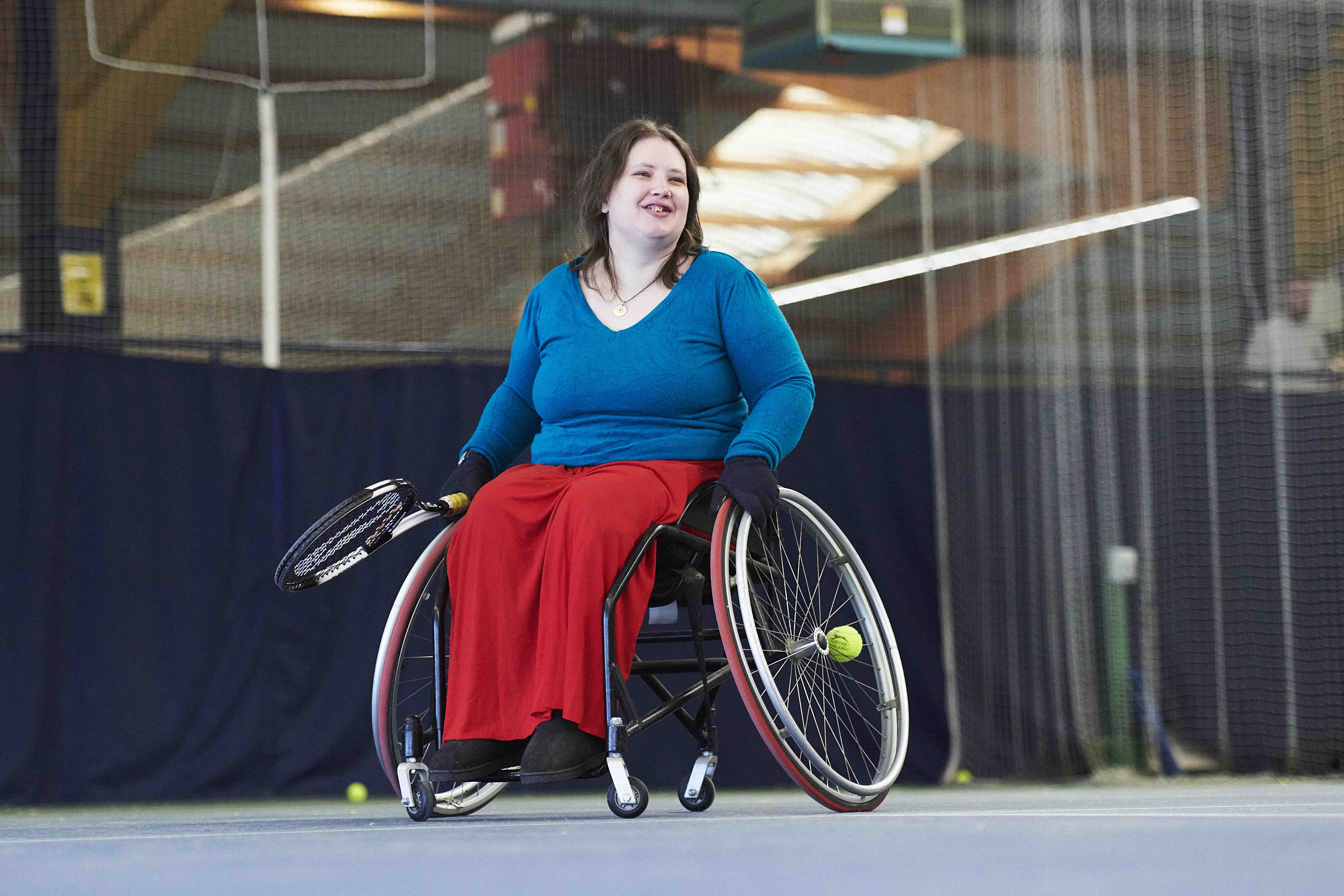 Wheelchair tennis player smiling on court.jpg