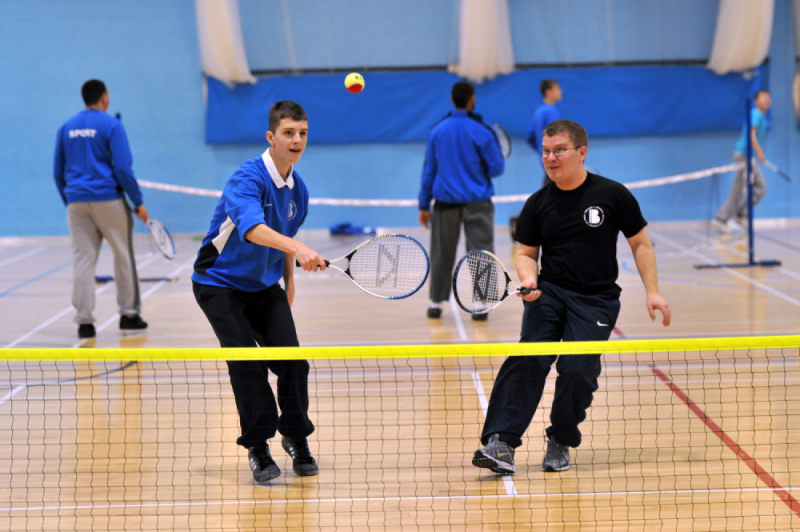 Two boys playing doubles together.