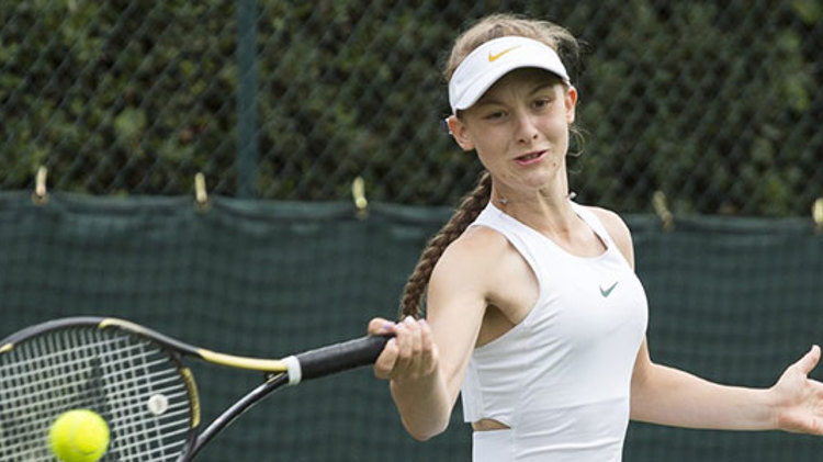junior tennis player hitting a forehand