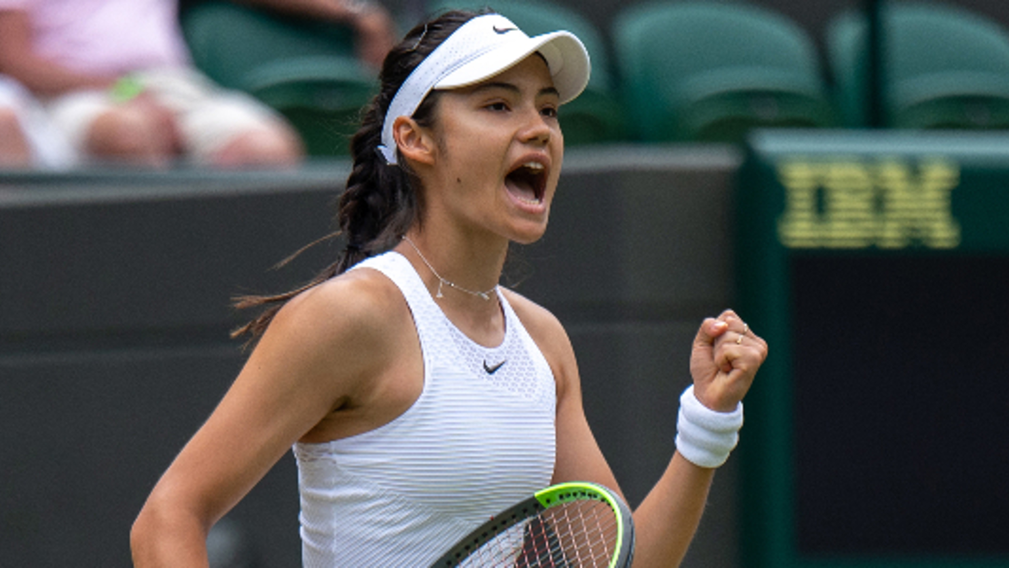 Emma Raducanu celebrating on a tennis court